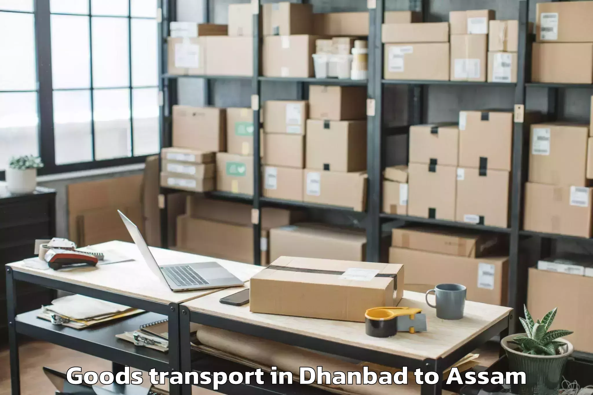 Easy Dhanbad to Darangamela Goods Transport Booking